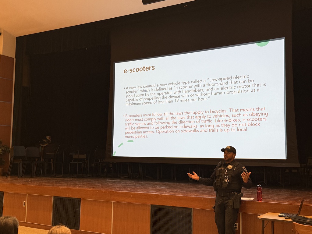 police officer presenting to  students