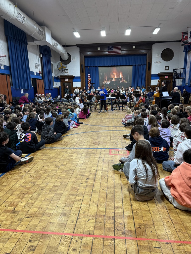 fifth grade musicians performing for the school