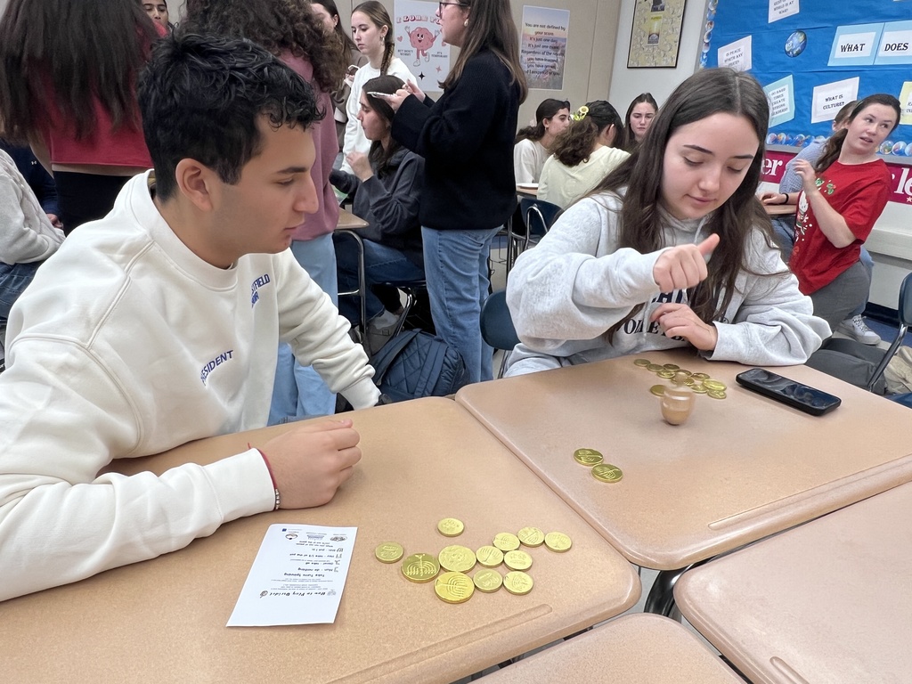 Students playing dreidel 