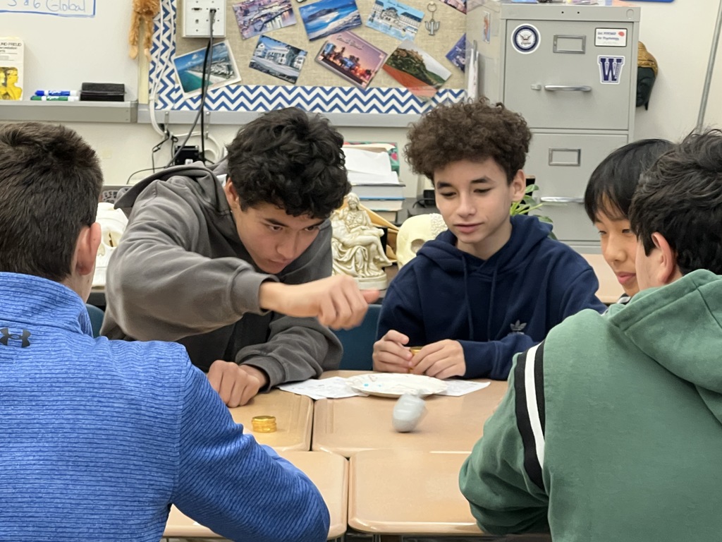 Students playing dreidel 