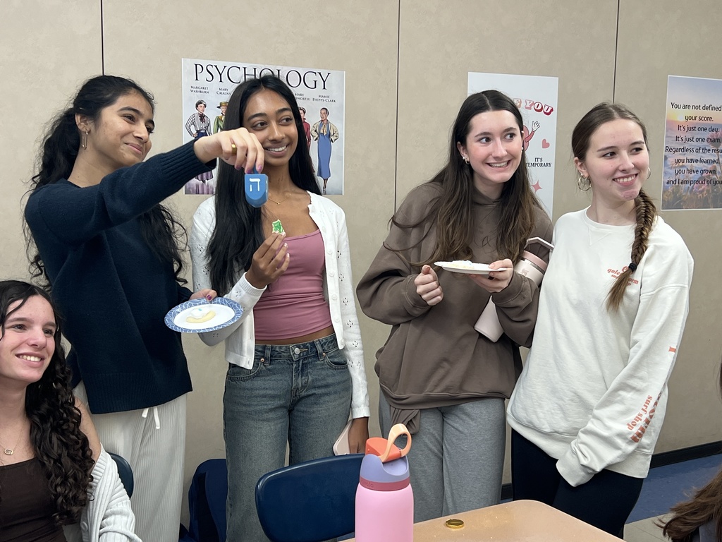 Students showing dreidel 