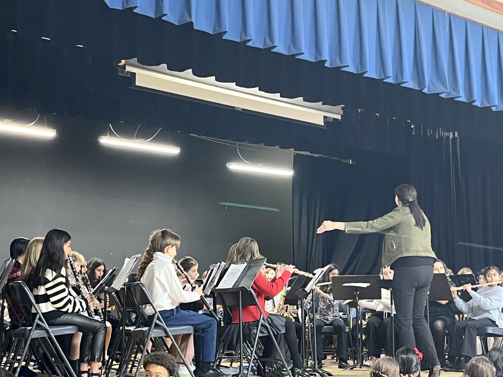 The instructor conducts the band.