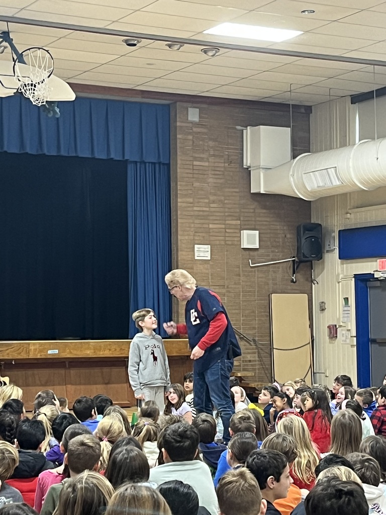 Presenter tells a story with the help of a student.