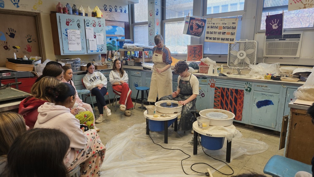 student on clay wheel