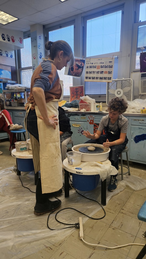 student working on clay wheel