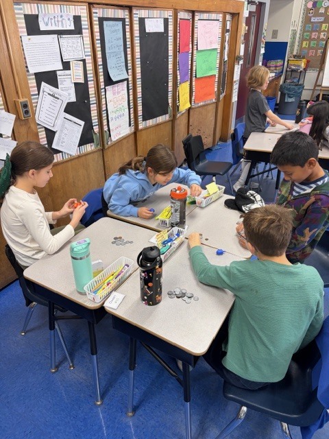 Students playing the dreidel game.