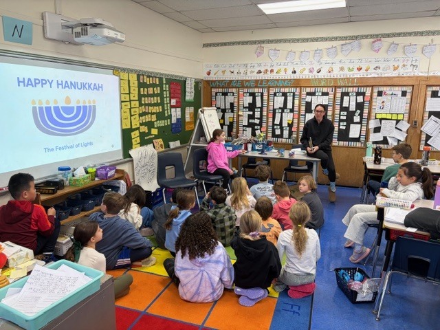 Mrs. B and her daughter and sharing the traditions with the class. 