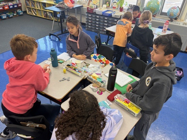 Students playing the dreidel game.