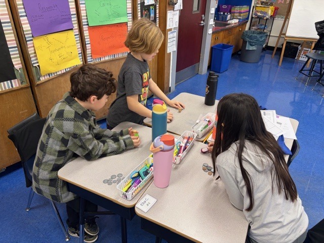 Students playing the dreidel game.