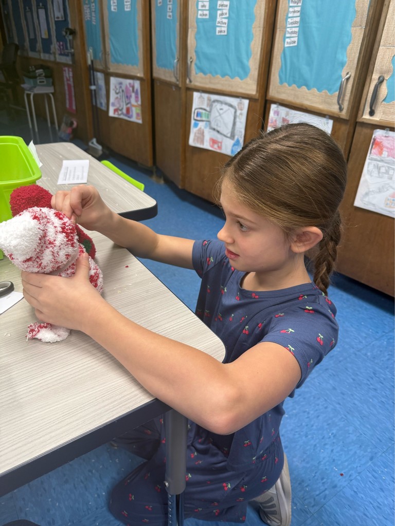 Student decorating her sock snowman.
