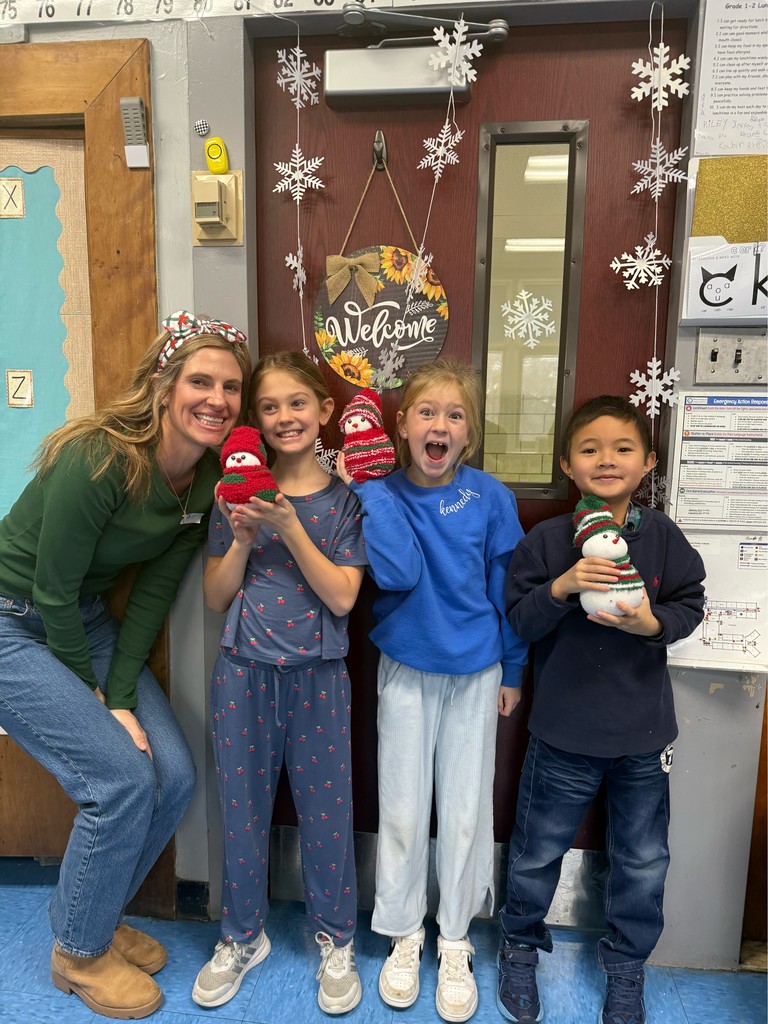 Parent and children pose with their sock snowmen.