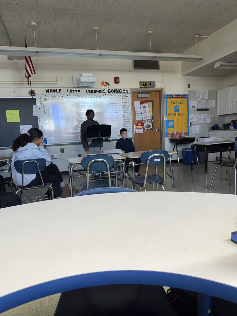 students presenting at the front of the class