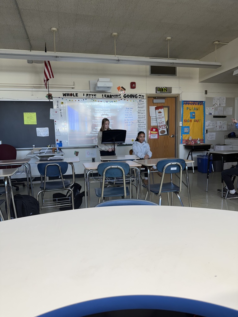 students presenting at the front of the class