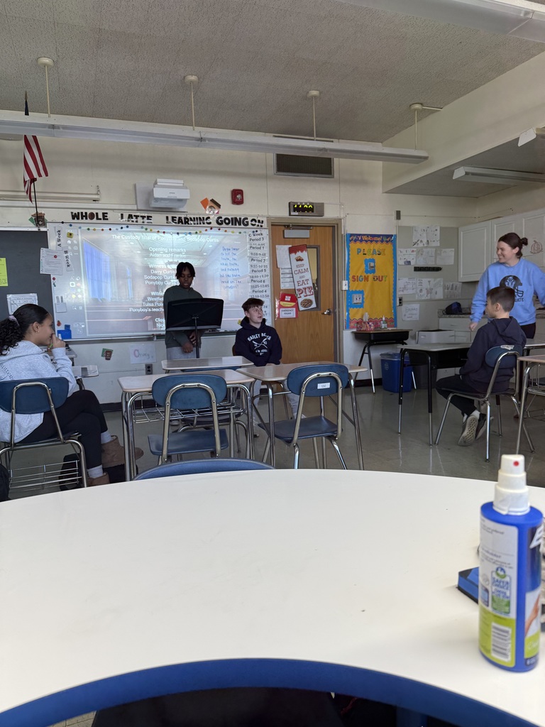 students presenting at the front of the class