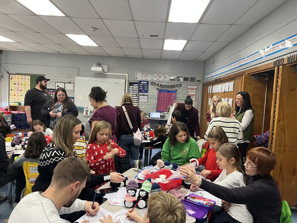 Students and families making sock penguins. 