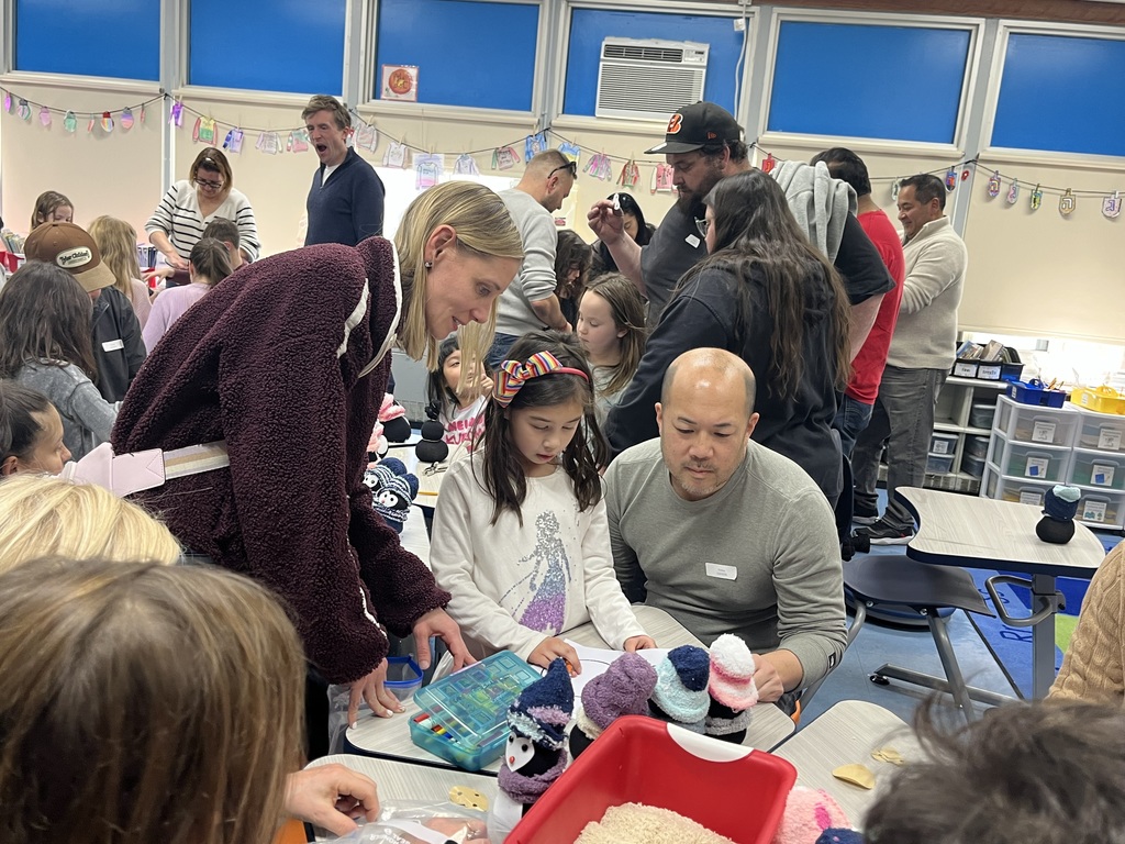 Students and families making sock penguins. 