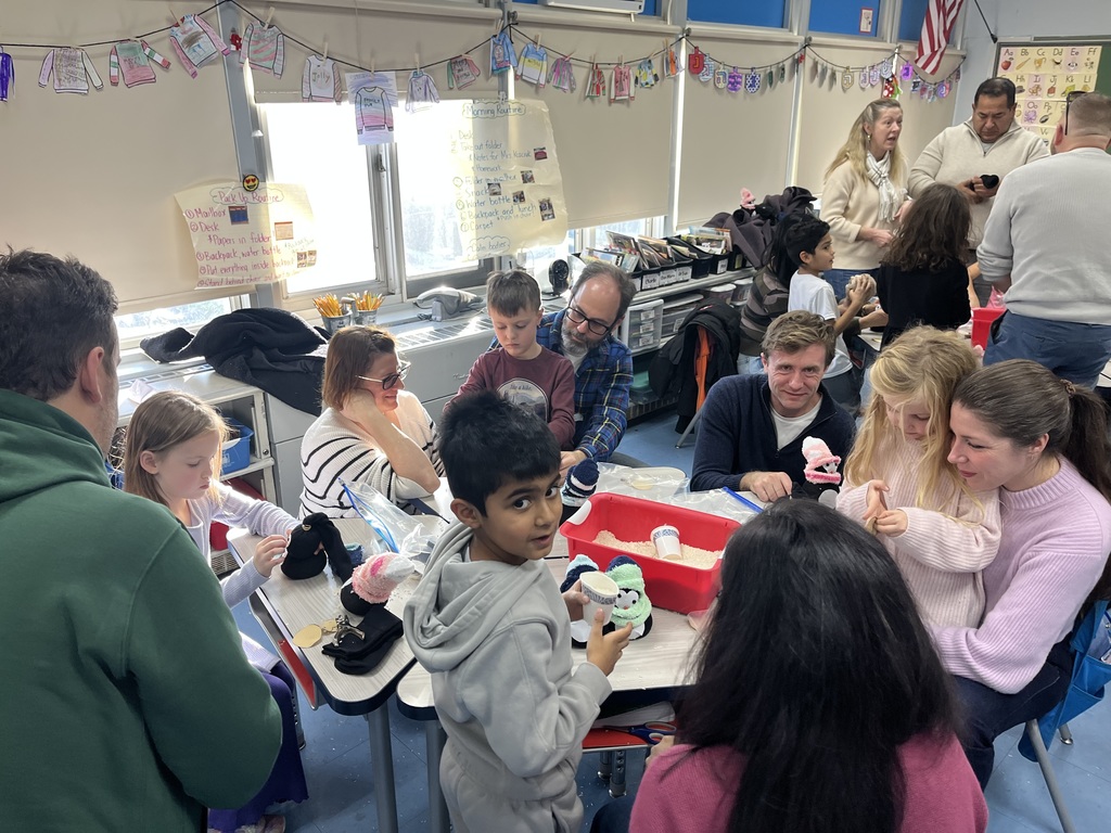 Students and families making sock penguins. 