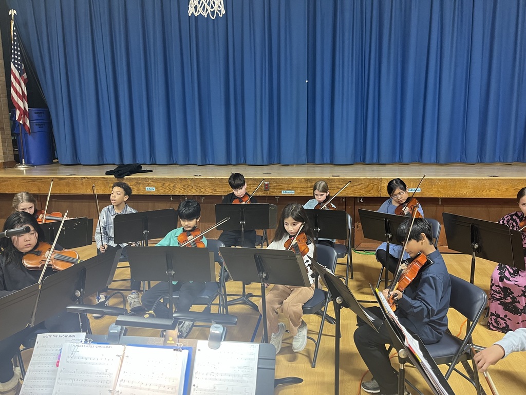 Orchestra students are playing their instruments.