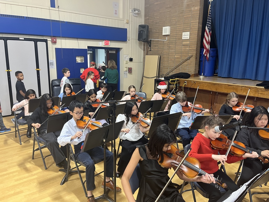 Orchestra students are playing their instruments.