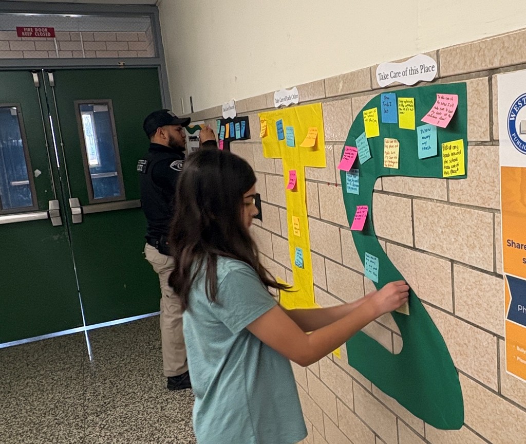 Student and Officer Benny posting resolution