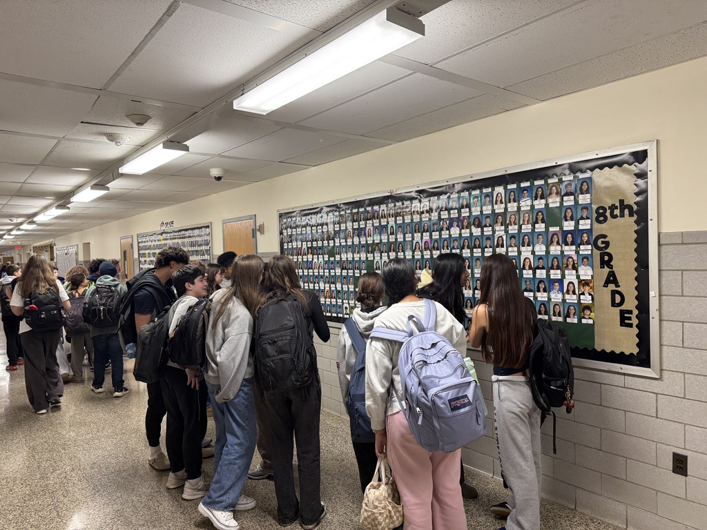students looking at bulletin board