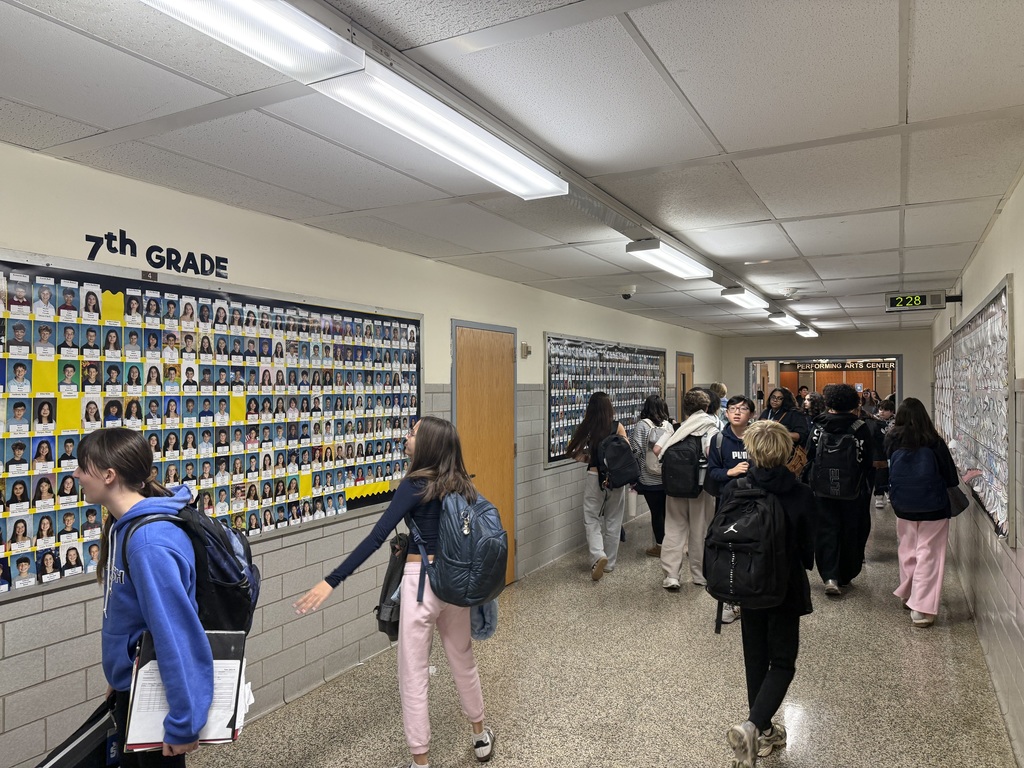 students looking at bulletin board