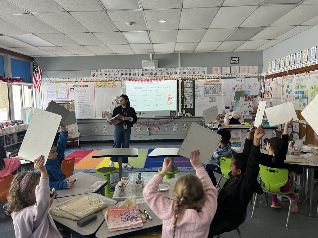 Students show their slates to the teacher.