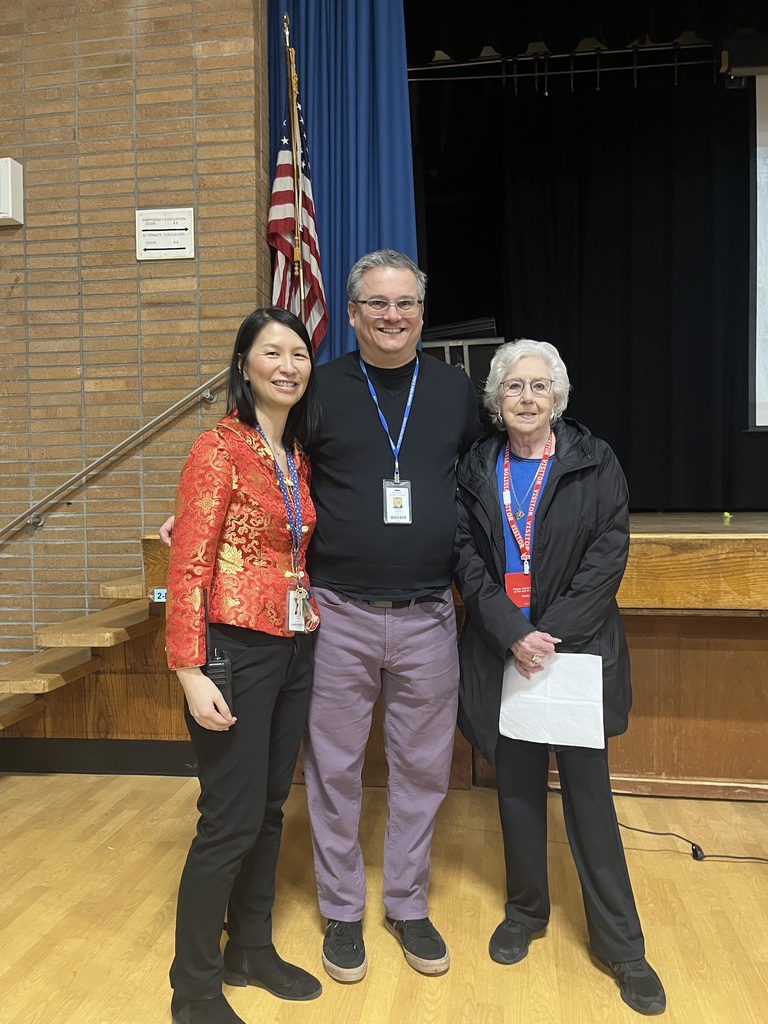 The principal, teacher and presenter are photographed together.