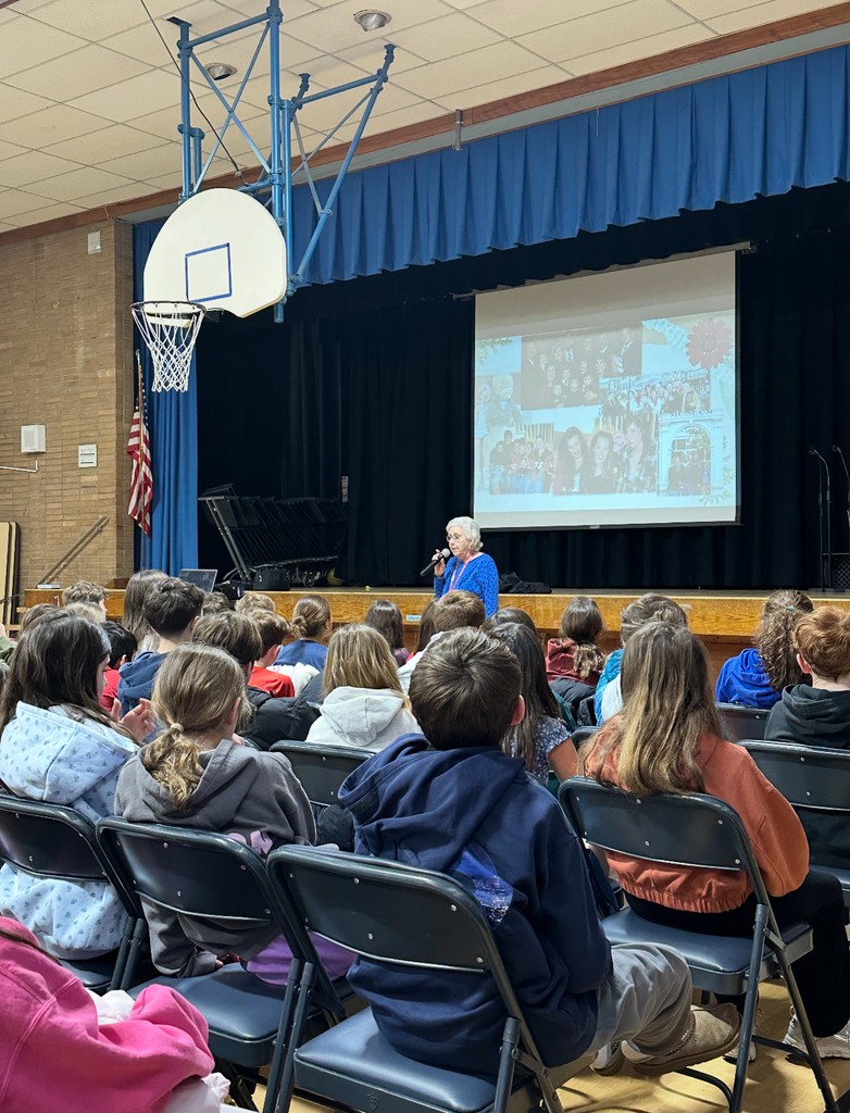 5th grade students listening to speaker