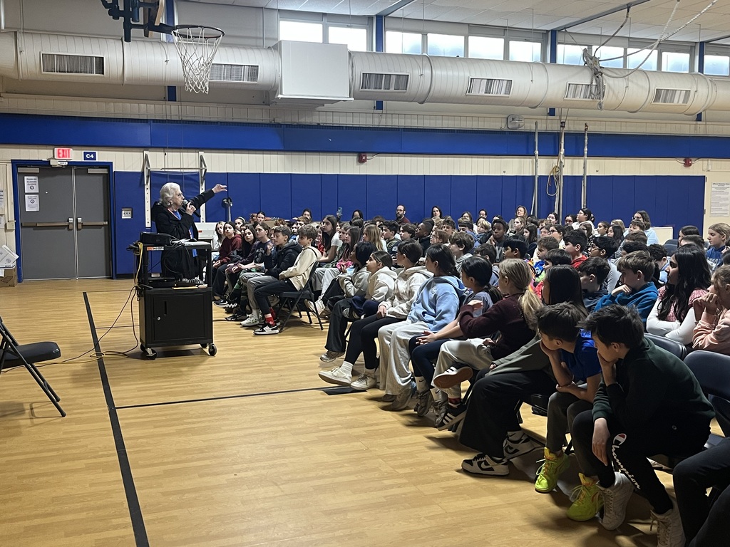 5th grade students listening to speaker