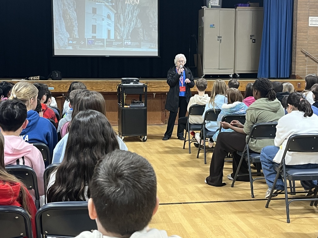 5th grade students listening to speaker
