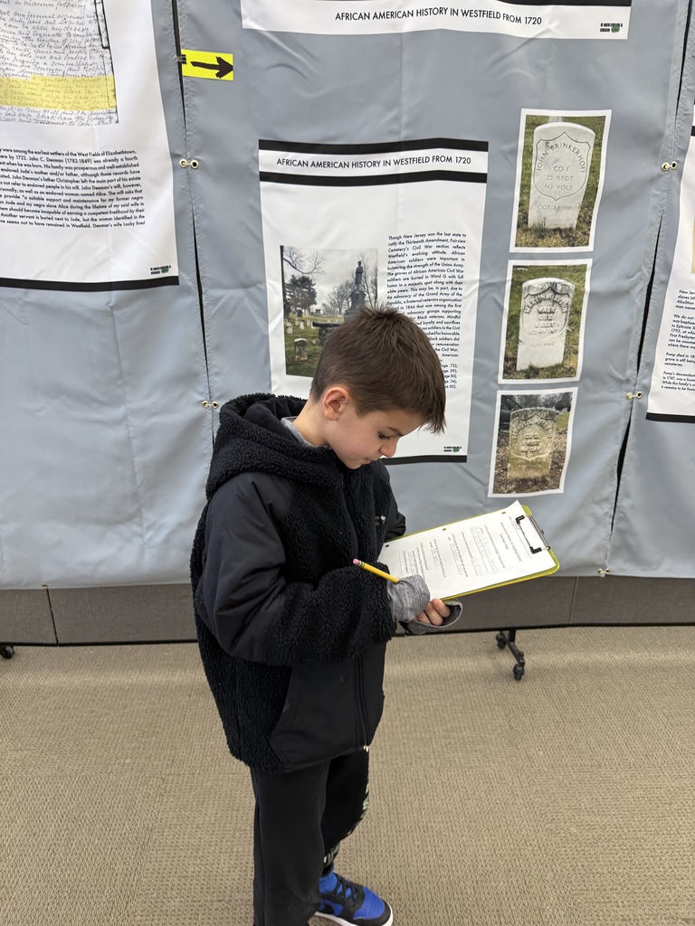 student standing by exhibit