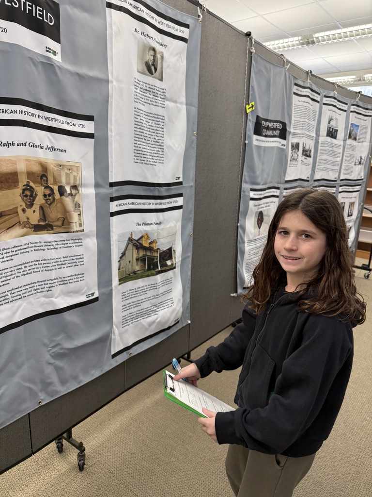 student standing by exhibit