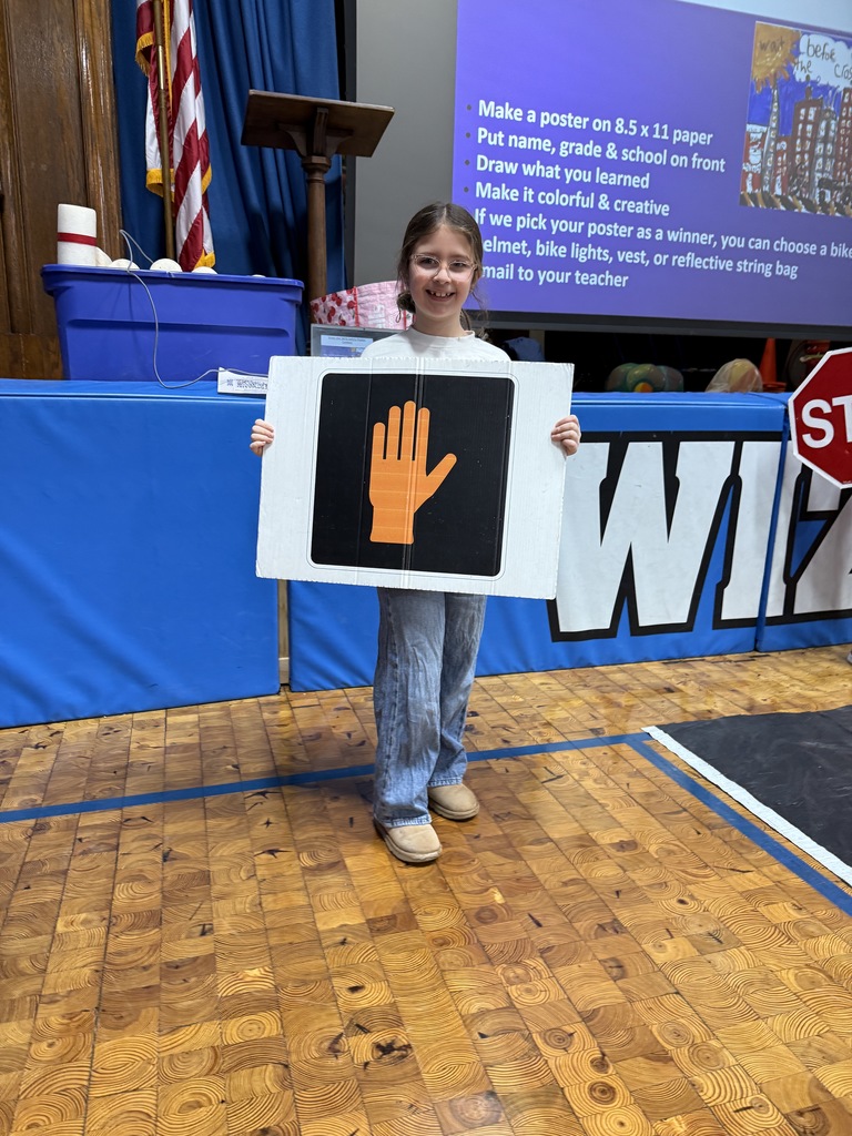 Wilson second graders holding wait sign