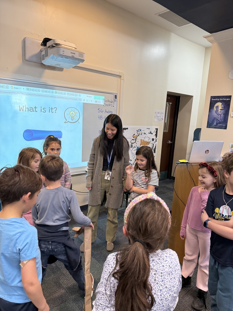 students standing in a circle with their teacher