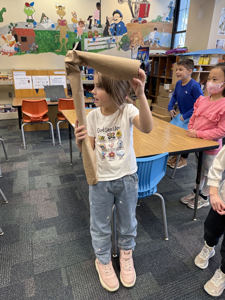 student holding a paper tube