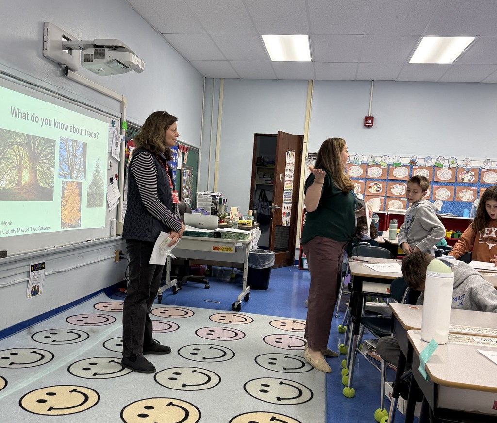 a tree steward and teacher standing in front of the class
