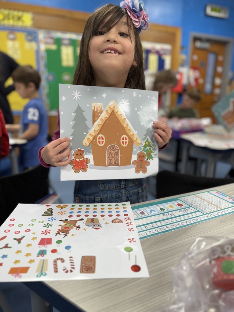 student holding up gingerbread craft