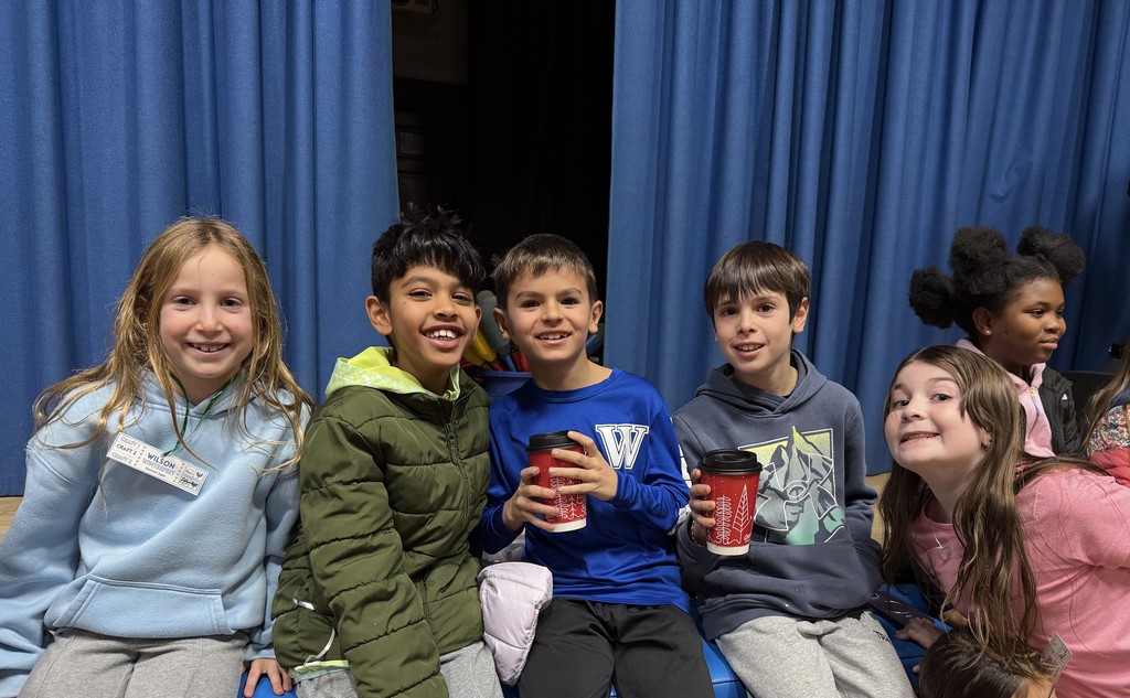 students at Winter Fest, sitting on the stage