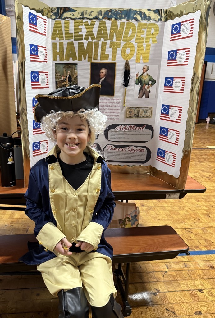 5th grade student in front of their board during the Wax Museum presentations