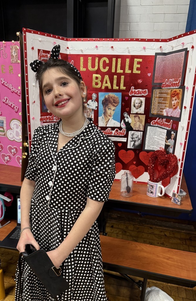 5th grade student in front of their board during the Wax Museum presentations