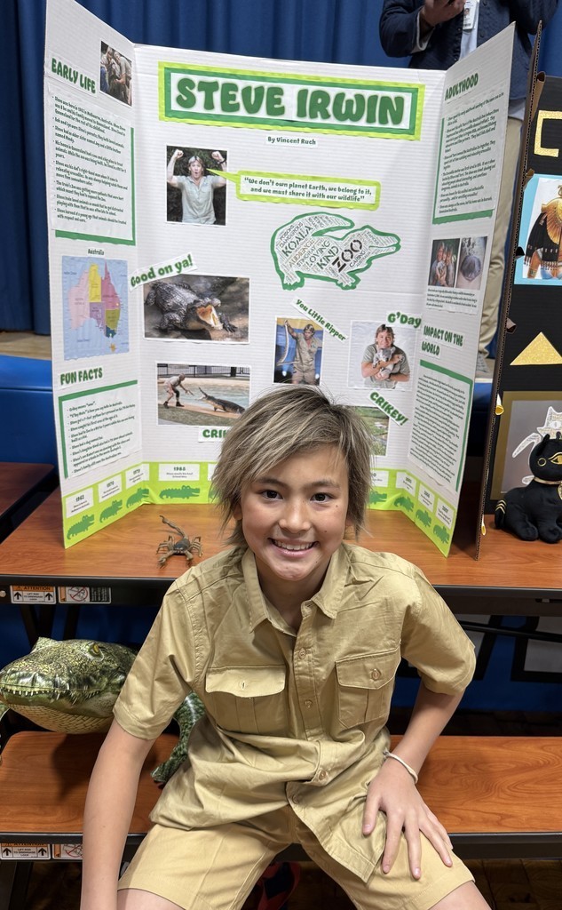 5th grade student in front of their board during the Wax Museum presentations
