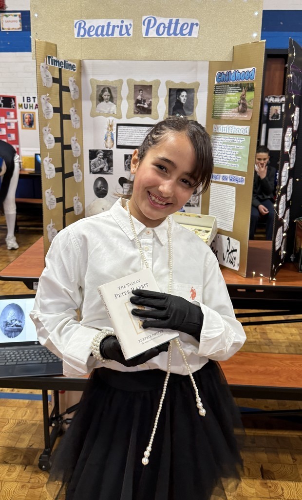 5th grade student in front of their board during the Wax Museum presentations