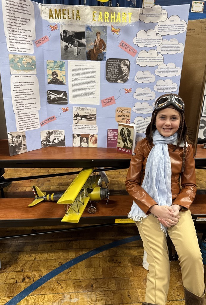 5th grade student in front of their board during the Wax Museum presentations