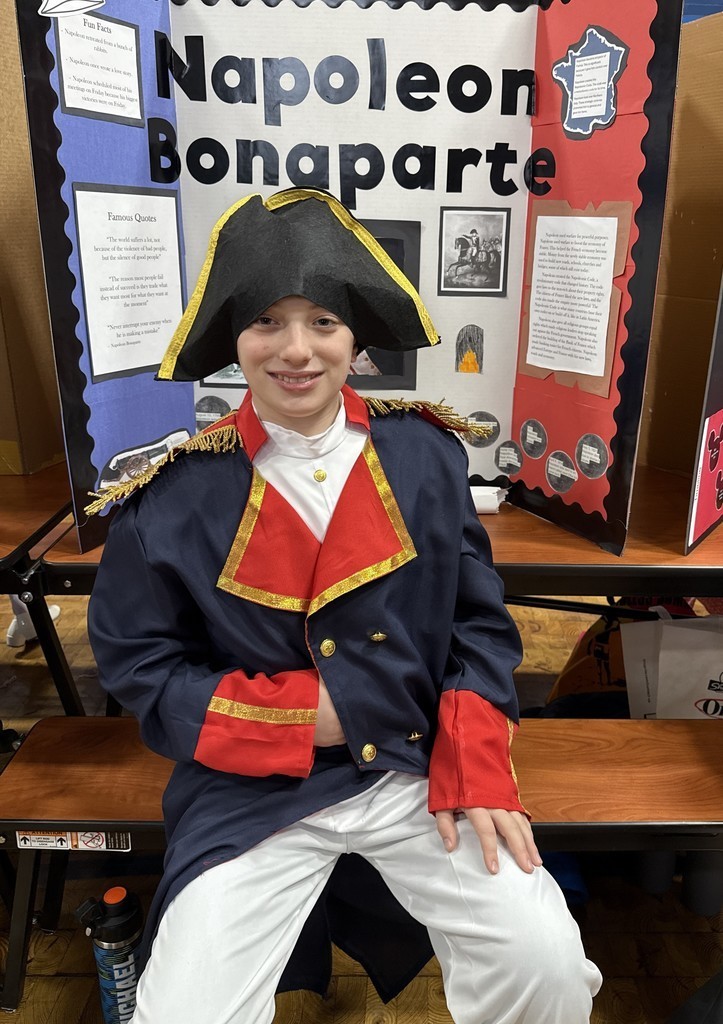 5th grade student in front of their board during the Wax Museum presentations