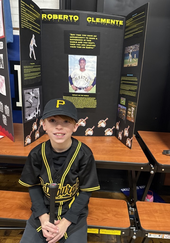 5th grade student in front of their board during the Wax Museum presentations