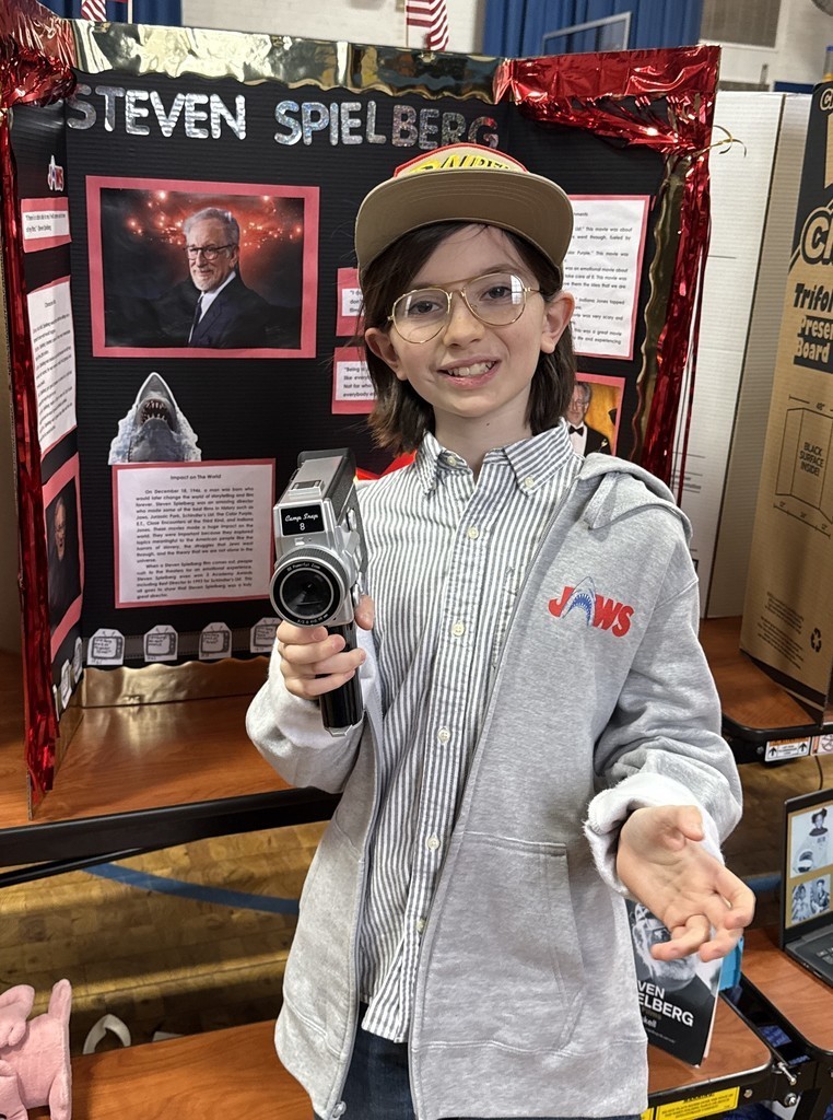 5th grade student in front of their board during the Wax Museum presentations