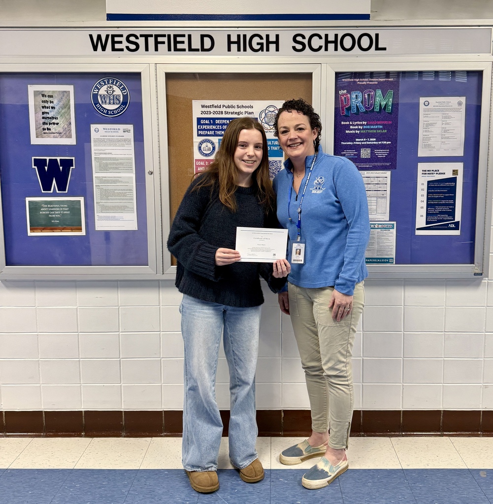 National Merit Scholarship Finalist Grace Matus receiving her certificate with WHS Principal Asfendis.