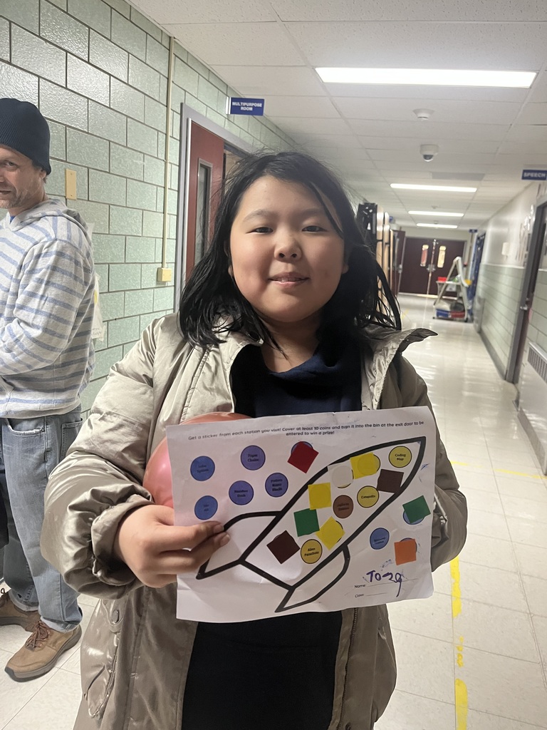 Student completed all the stations and shows her chart.