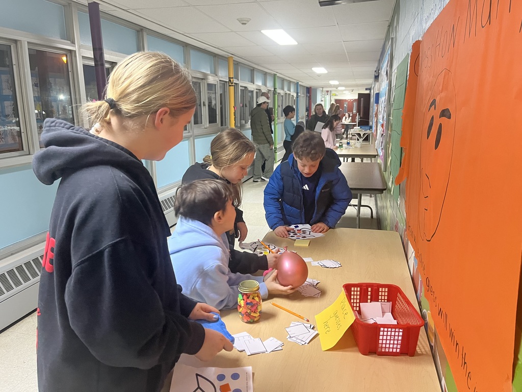 Students at the guessing jar station